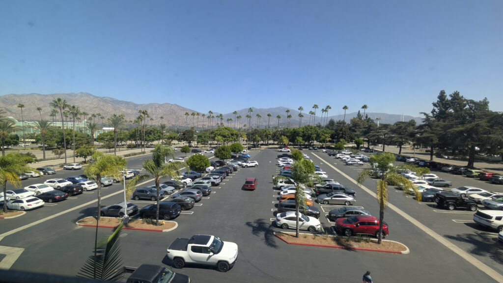 A view from the California Infusion Centers clinic showing a beautiful mountain range and palm trees with ample parking available in the lot below.