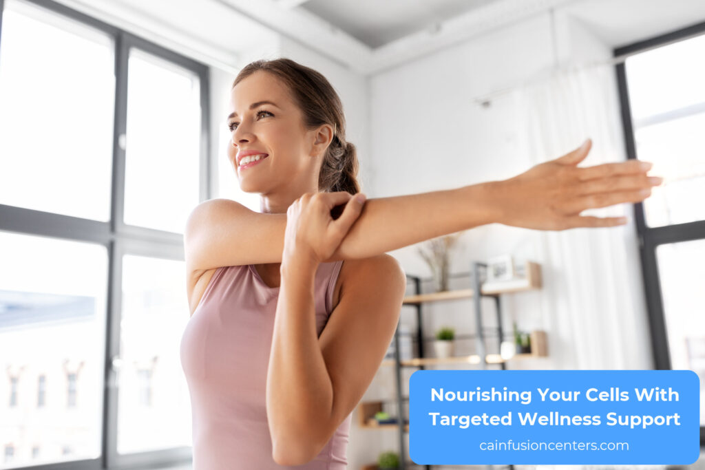 Woman stretching her arm in a bright living space, expressing energy, balance, and a calm start to her wellness routine.