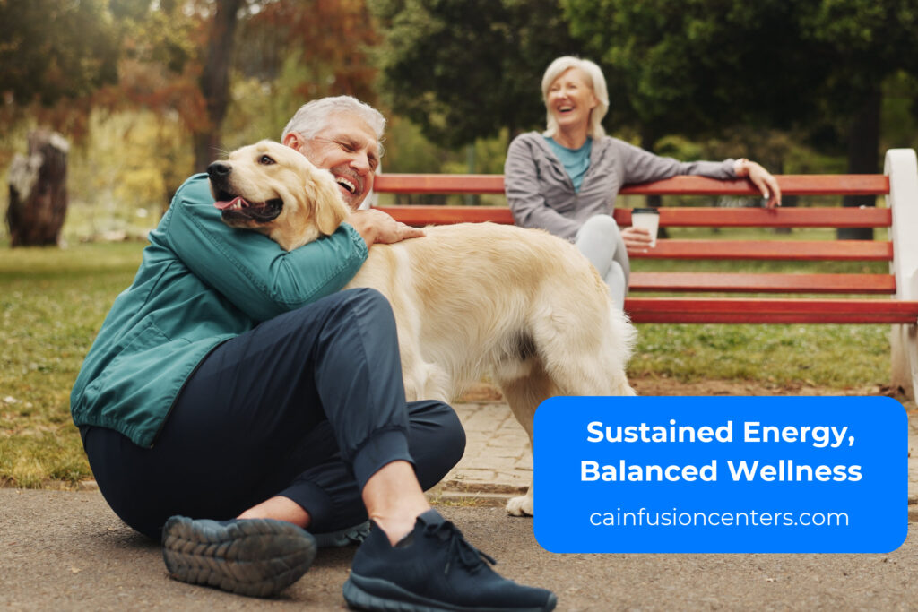 Older couple smiling outdoors with their dog, symbolizing vitality and long-term wellness after IV therapy.