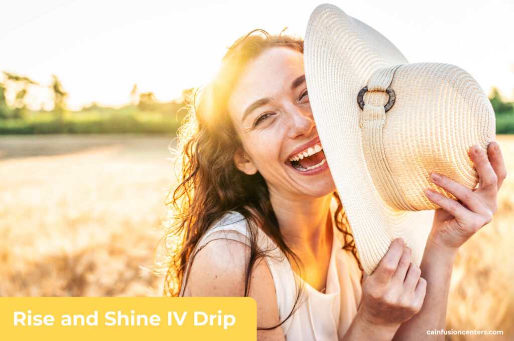 Smiling woman outdoors holding a sun hat and enjoying renewed energy and hydration after Rise and Shine IV Therapy from California Infusion Centers.