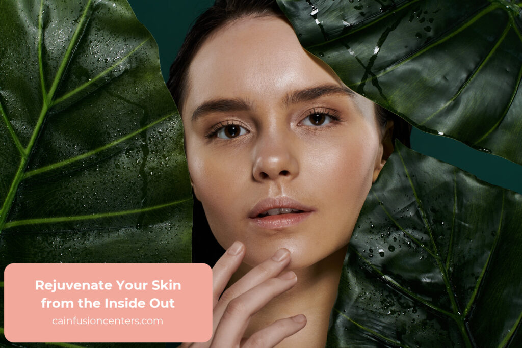 Close-up of a woman with glowing skin framed by green leaves, symbolizing natural hydration and cellular rejuvenation through anti-aging IV therapy in Los Angeles.